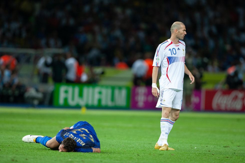 Marco Materazzi lies on the turf after being headbutted by Zinedine Zidane