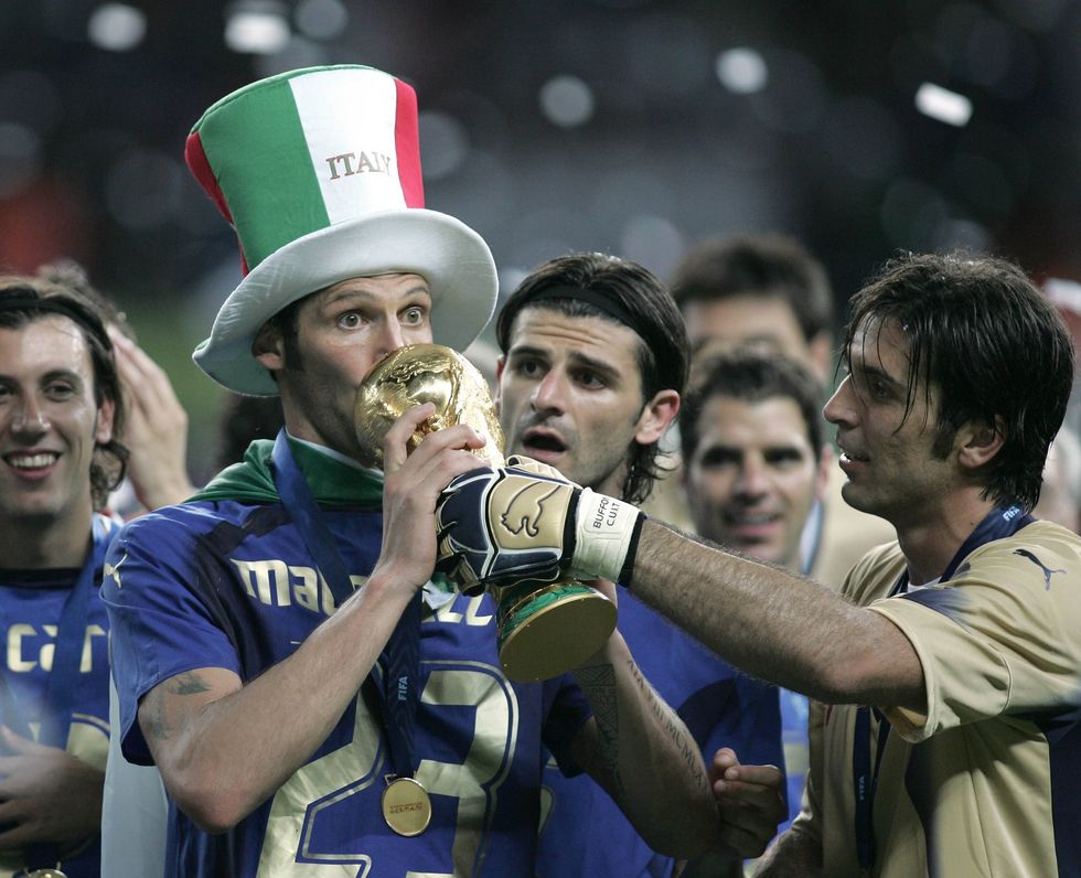 Marco Materazzi poses with the World Cup trophy after Italy's penalty shootout win over France