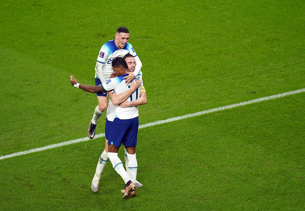 Marcus Rashford celebrates with Jordan Henderson and Phil Foden.