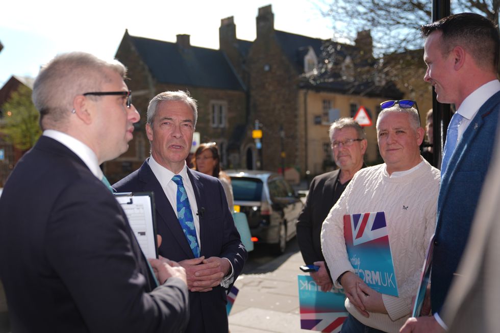 Mark Arnull (left) with Reform UK leader Nigel Farage (second left) and party supporters