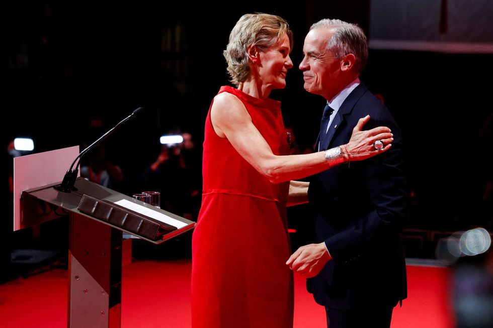 Mark Carney embraces his wife Diana Fox Carney at the Liberal Party election night headquarters in Ottawa