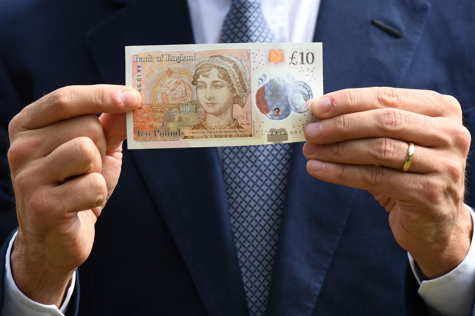 Mark Carney holding a \u00a310 banknote featuring Jane Austen
