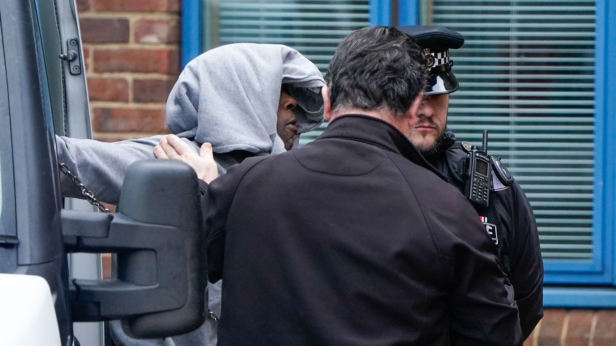 Mark Gordon is led into Crawley Police Station