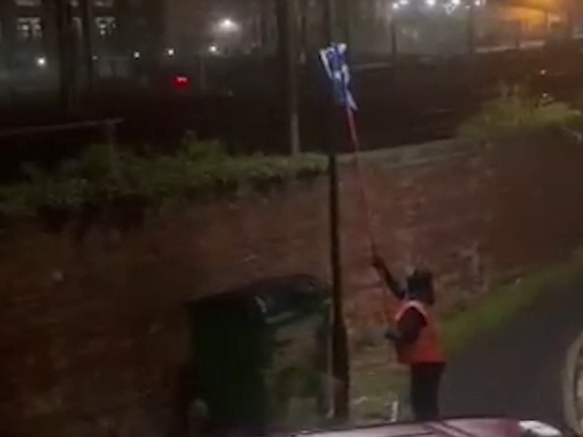 Masked man removing flag
