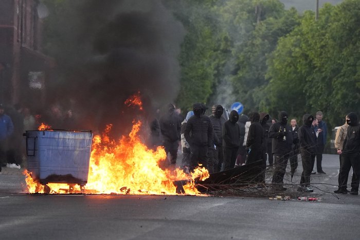 Masked men also set fire to a wheelie bin in the Northern Irish capital