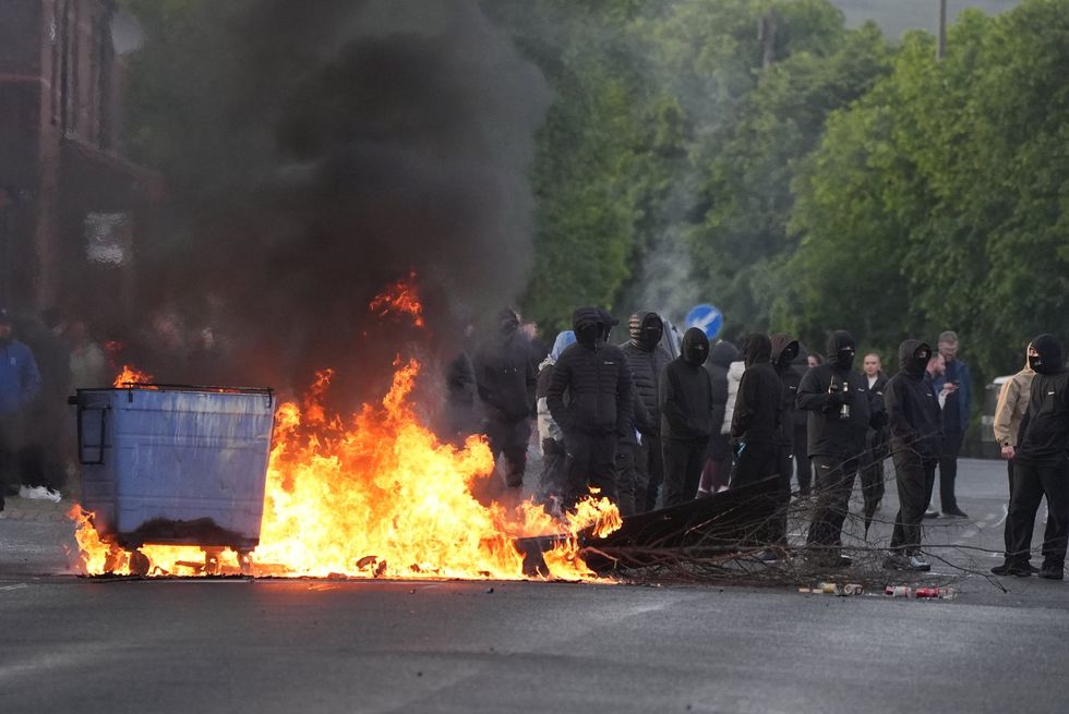 Masked men also set fire to a wheelie bin in the Northern Irish capital