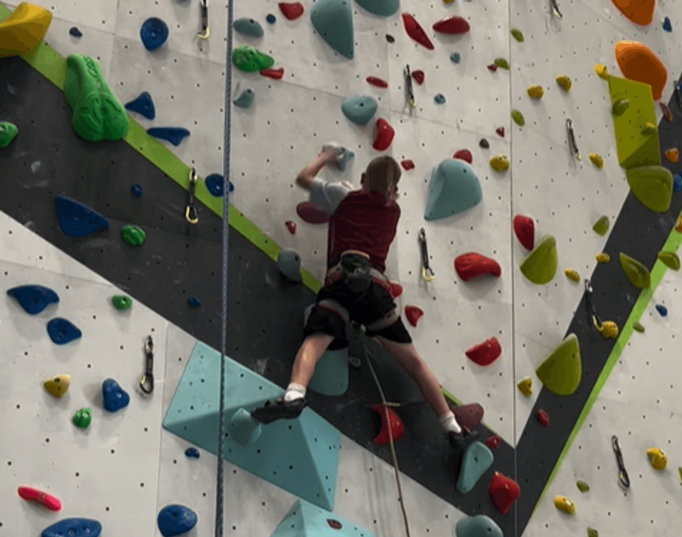 Mason climbing the wall