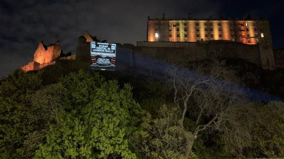 Massive anti-digital ID display projected onto historic Scottish landmark