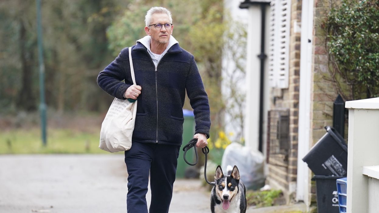Match Of The Day host Gary Lineker returns to his home in London with his dog.