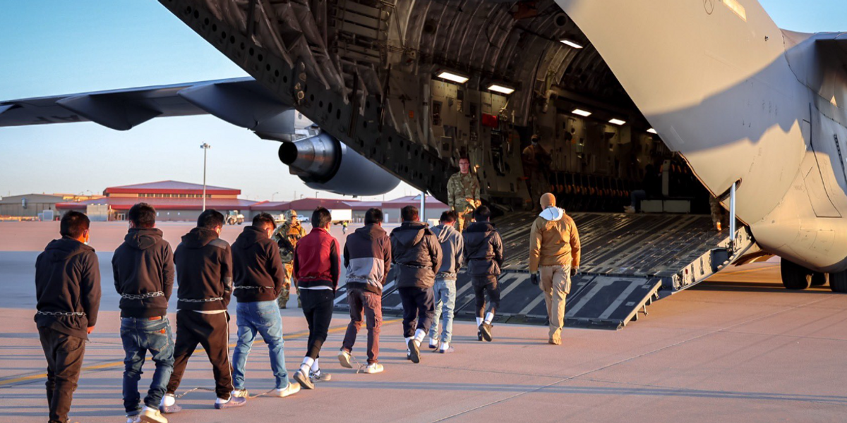 NextImg:'Deportation flights have begun!' Trump sends clear message as shackled migrants loaded onto plane