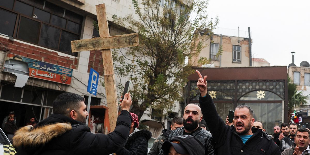 NextImg:Protests erupt in Syria after masked gunmen set fire to Christmas tree