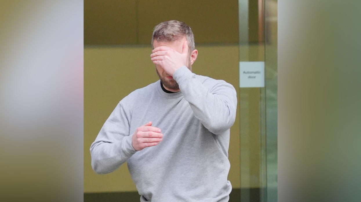 Matthew Trickett covers his face as he leaves Westminster Magistrates' Court