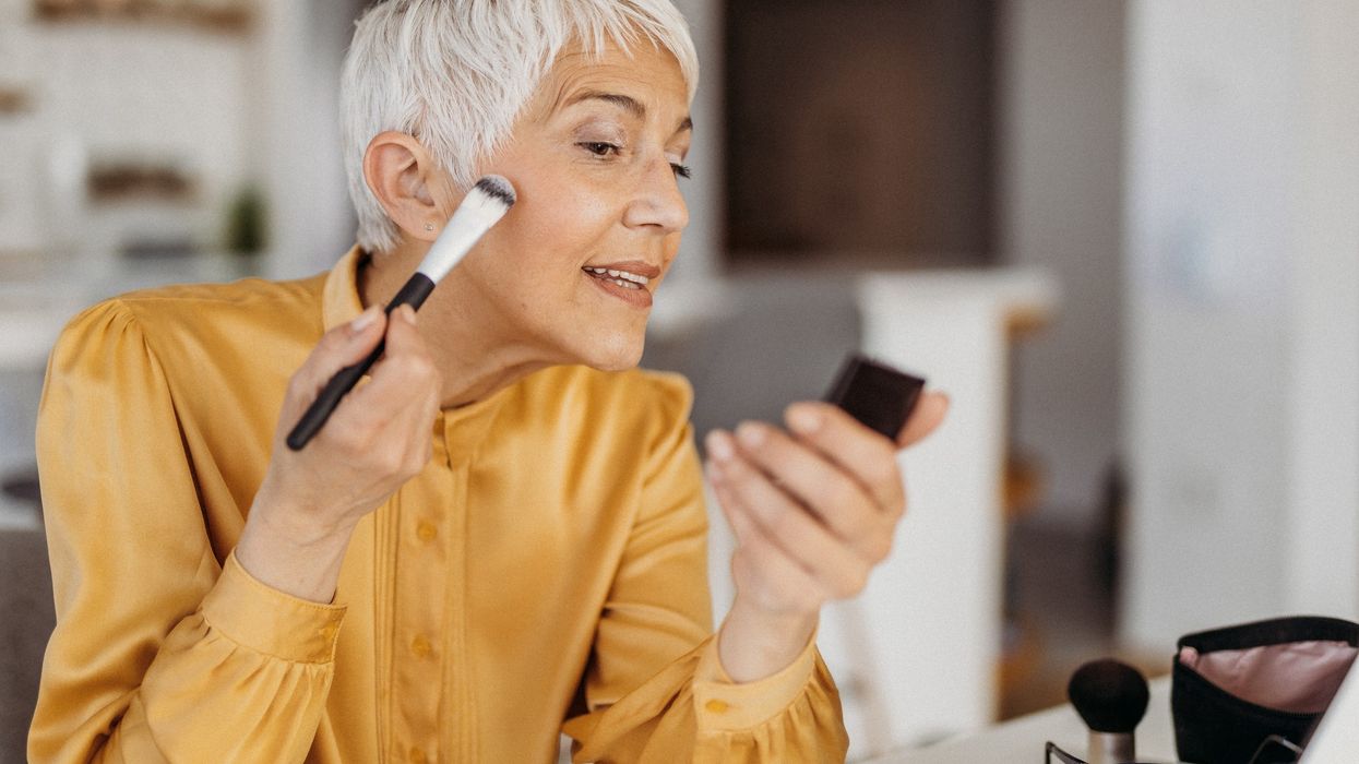 Mature woman applying makeup