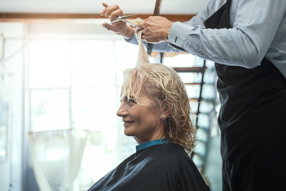 Mature woman having a fringe cut