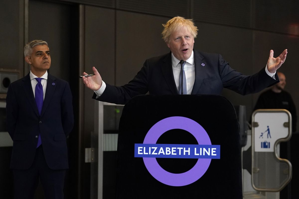 Mayor of London Sadiq Khan (left) looks on as former Prime Minister Boris Johnson makes a speech at Paddington station in London