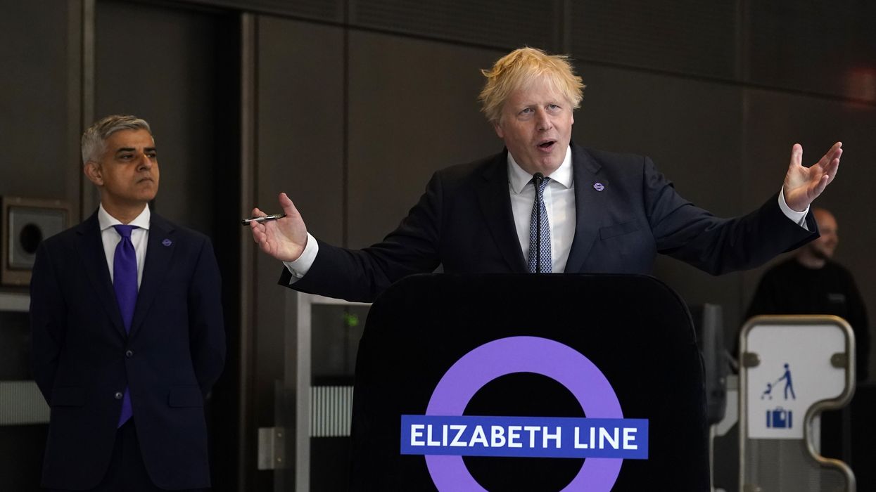 Mayor of London Sadiq Khan (left) looks on as former Prime Minister Boris Johnson makes a speech at Paddington station in London
