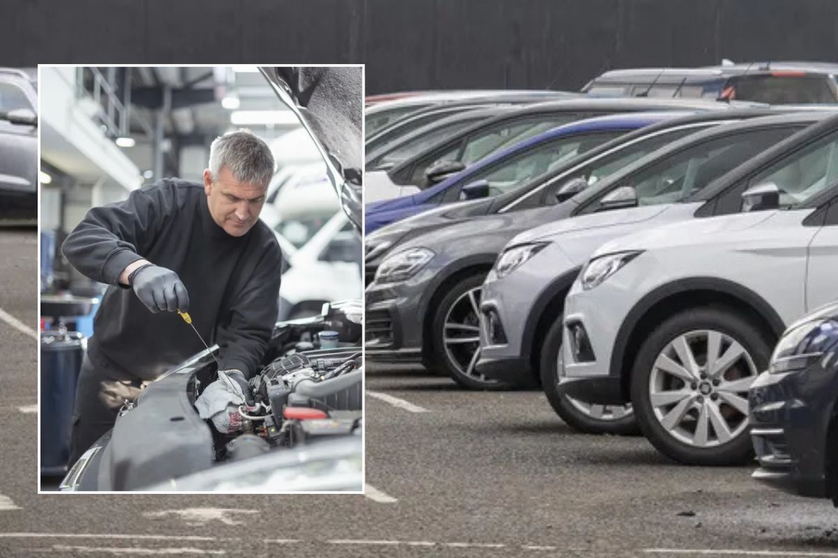 Mechanic conducting an MOT test and parked cars