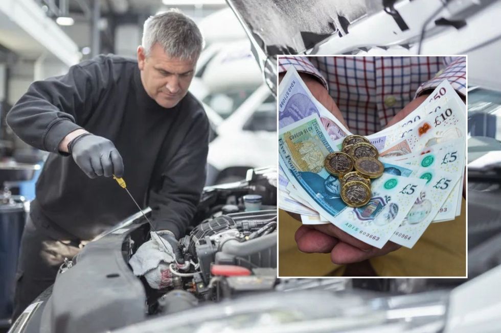 Mechanic working on a car and a man holding money