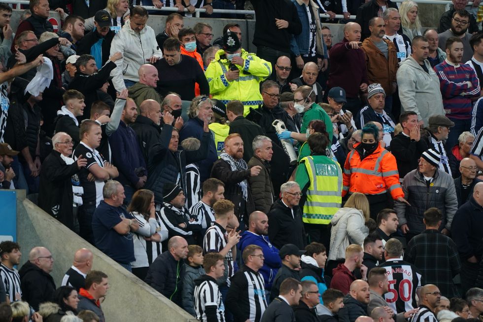 Medical personal are called to assist a fan in the stands during the Premier League match at St. James' Park, Newcastle. Picture date: Sunday October 17, 2021.