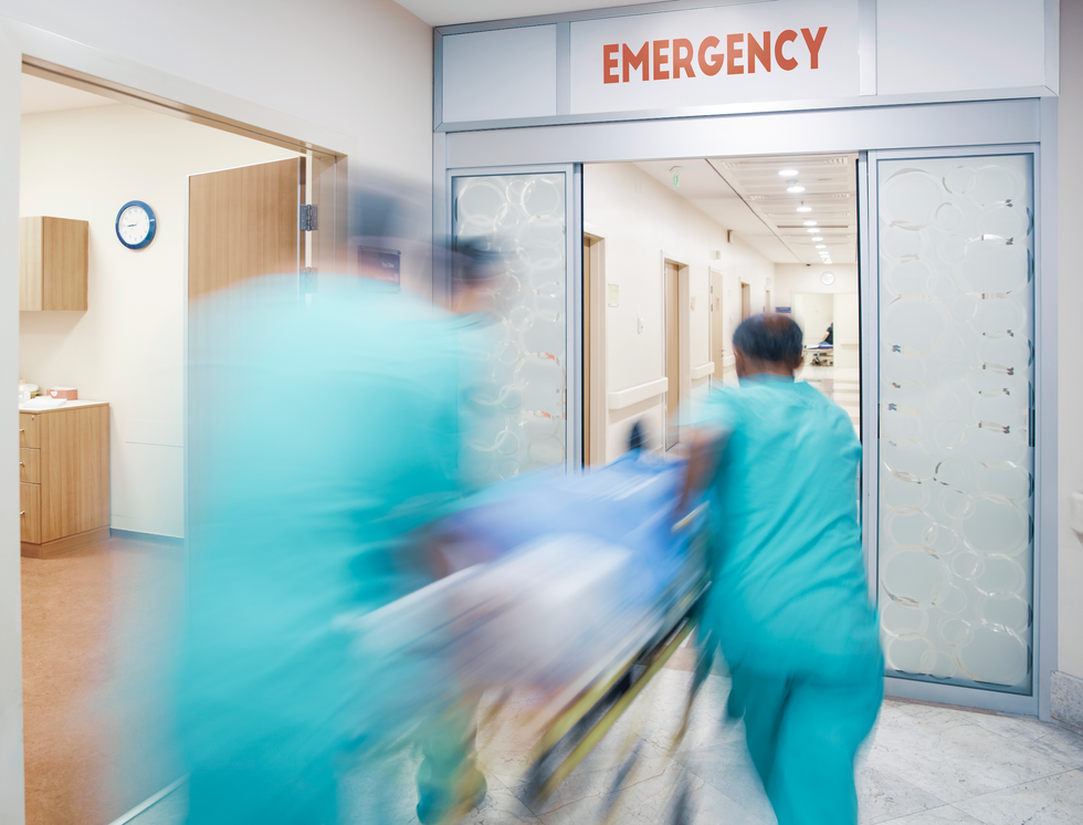 Medical personnel rushing through hospital