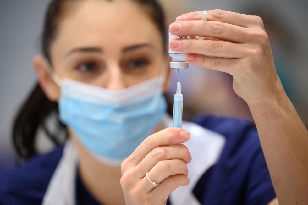 Medical staff and volunteers prepare shots of the Moderna Covid-19 vaccine at a vaccination centre.