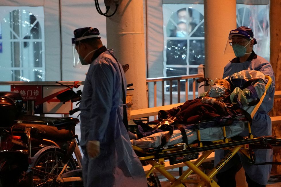 Medical staff moves a patient into a fever clinic at a hospital, as coronavirus disease (COVID-19) outbreaks continue in China,