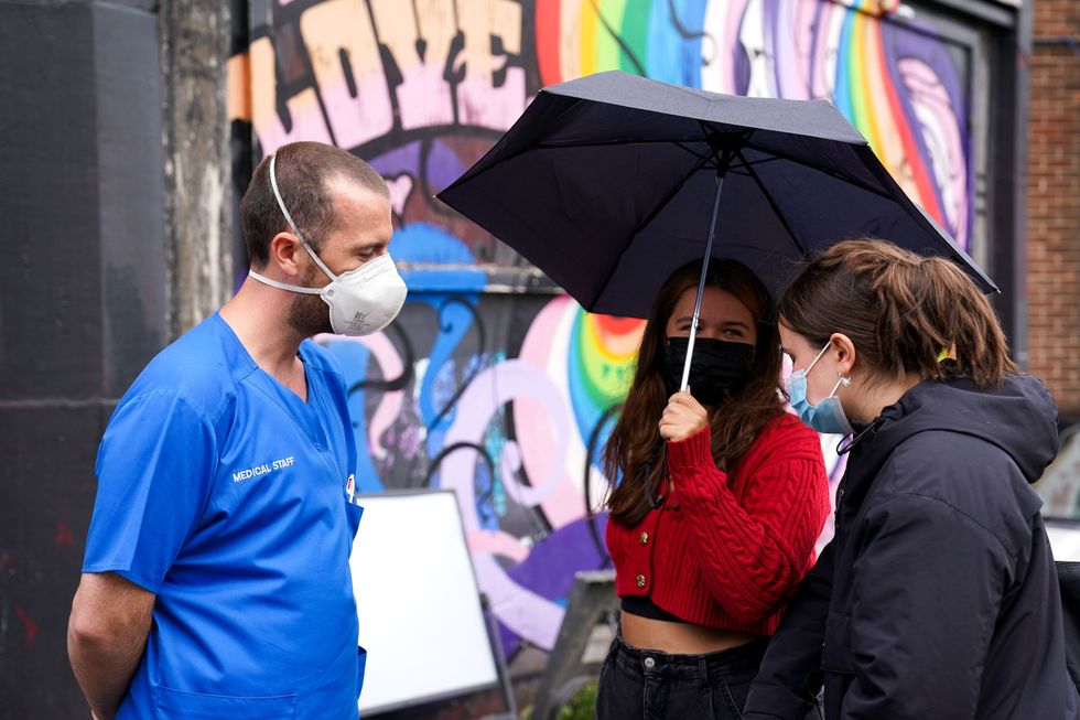 Medical staff speak to people regarding coronavirus vaccinations, outside the UK's first nightclub vaccine centre which has been set up at Birmingham's oldest and largest LGBT venue, the Nightingale Club.