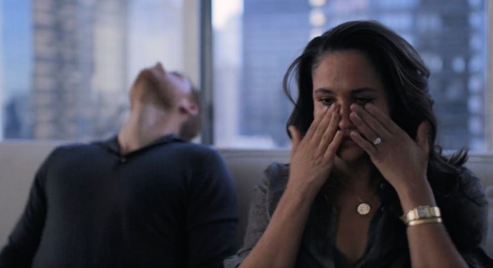 Meghan is seen appearing to wipe away tears.