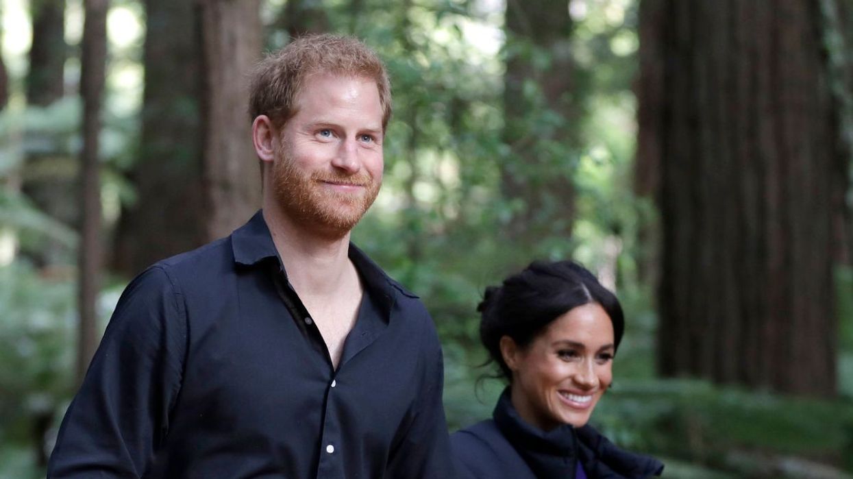 Meghan Markle and Prince Harry walking in a forest