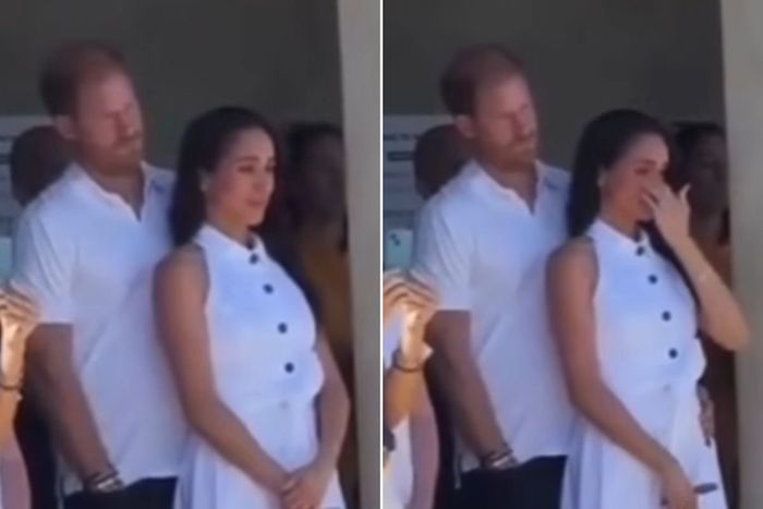 Meghan Markle wipes away a tear alongside Prince Harry