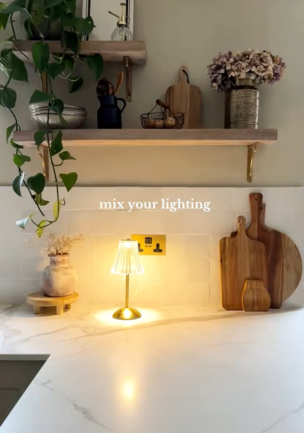 Mel sharing a picture of a kitchen with a decorative lamp shade on a kitchen counter