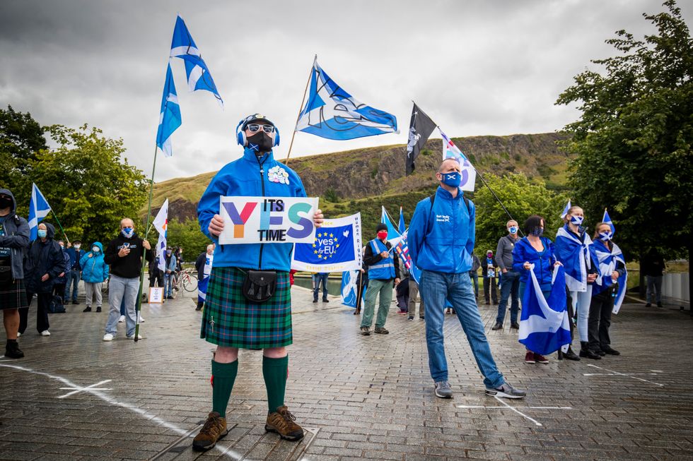 Members from All Under One Banner take part in a static demonstration for Scottish independence outside the Scottish Parliament in Edinburgh.