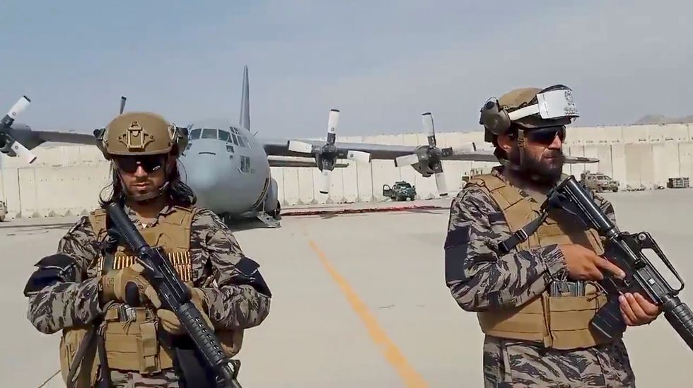 Members of Badri 313 military unit stand guard as Taliban spokesman Zabihullah Mujahid delivers his remarks at Kabul's airport, Afghanistan August 31, 2021 in this still image obtained from a handout video. Taliban/Handout via REUTERS.