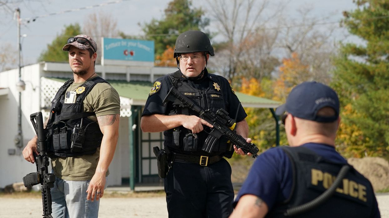 Members of law enforcement search a farm, as the search for the suspect in the deadly mass shootings in Lewiston continues, in Lisbon Falls, Maine