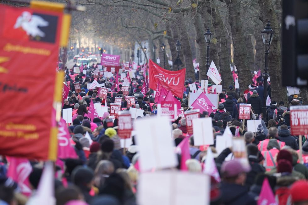 Members of the Communication Workers Union (CWU) march from Parliament Square to St James's Park, London, during a rally with Royal Mail workers to mark another strike in the increasingly bitter dispute over jobs, pay and conditions. Picture date: Friday December 9, 2022.