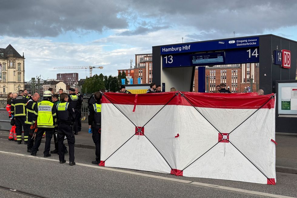 Members of the emergency services work at the scene at Hamburg's main train station where several people have been stabbed