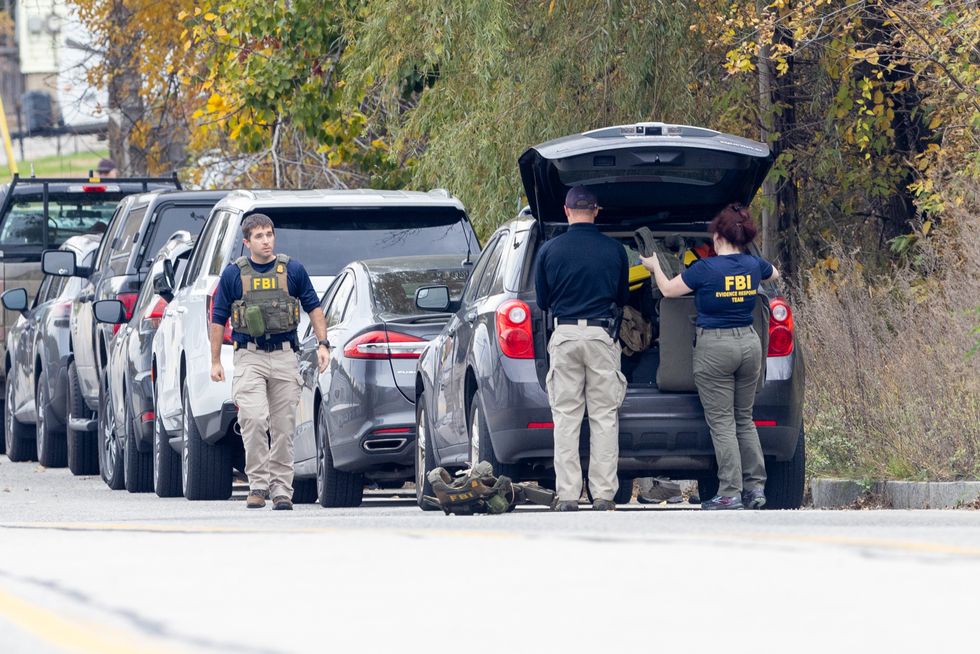 Members of the FBI Evidence Response Team gather at the site of a mass shooting at Schemengees Bar and Grille on October 26