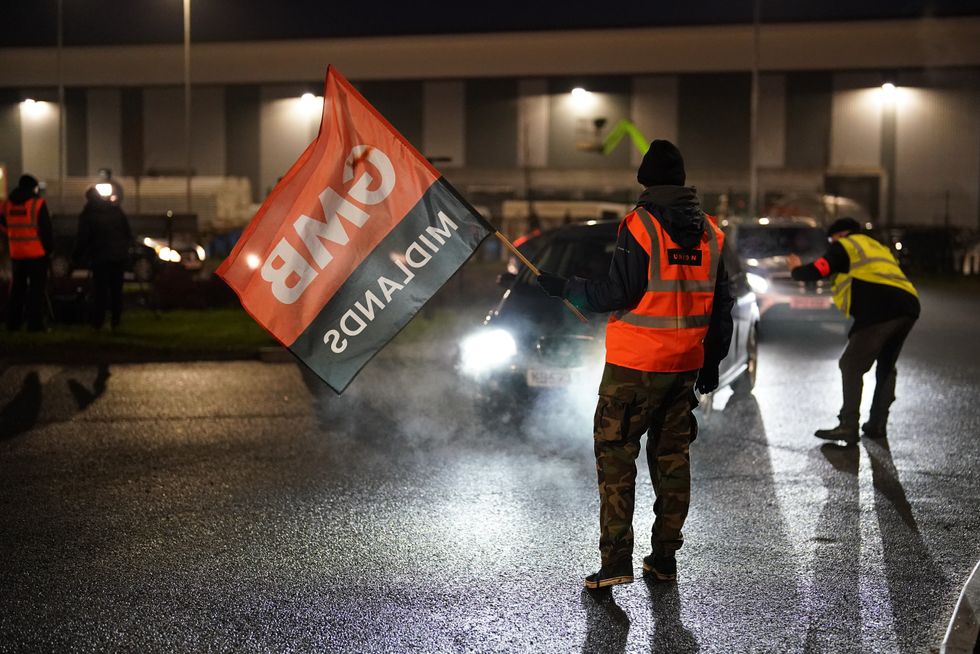 Members of the GMB union, on the picket line outside the Amazon fulfilment centre in Coventry, approach cars to dissuade colleagues from entering the plant, as Amazon workers stage their first ever strike in the UK in a dispute over pay. Picture date: Wednesday January 25, 2023.