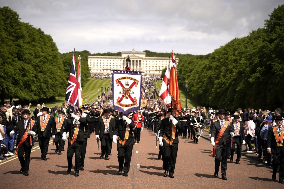 Members of the Grand Orange Lodge of Ireland at the start of the Northern Ireland centenary parade from Stormont towards City Hall in Belfast, to commemorate the creation of Northern Ireland. Picture date: Saturday May 28, 2022.