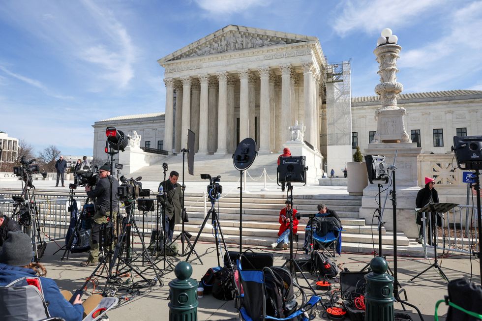 Members of the media outside Supreme Court
