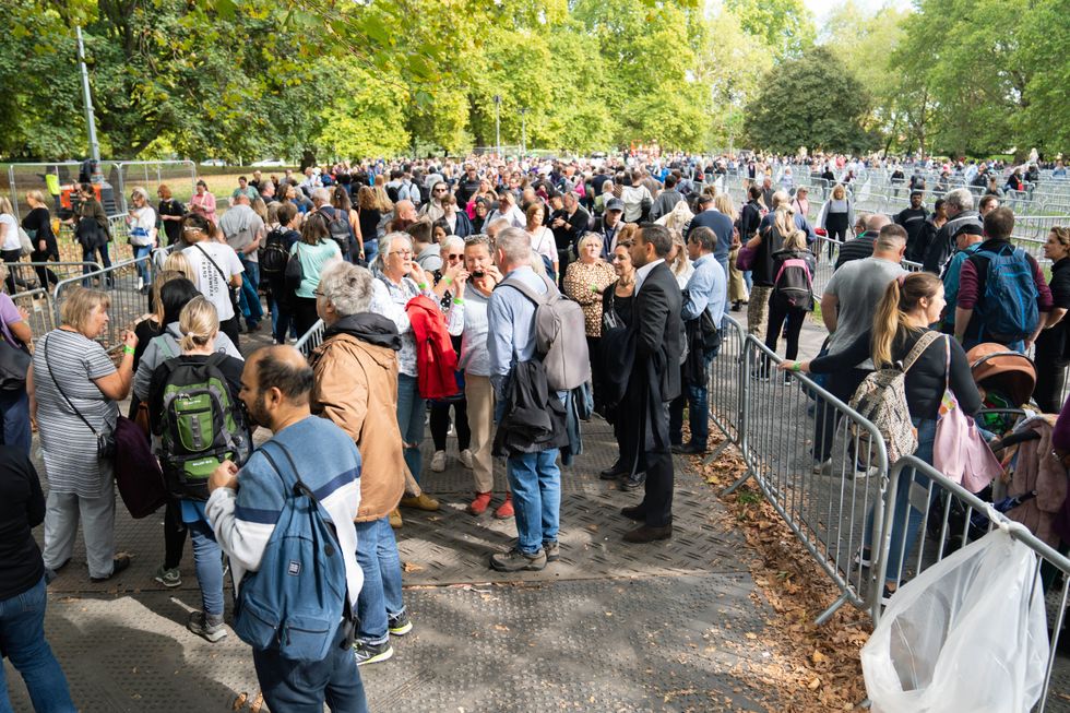 Members of the public at the end of the queue in Southwark Park, south London, as they wait to view Queen Elizabeth II lying in state. Picture date: Sunday September 18, 2022.