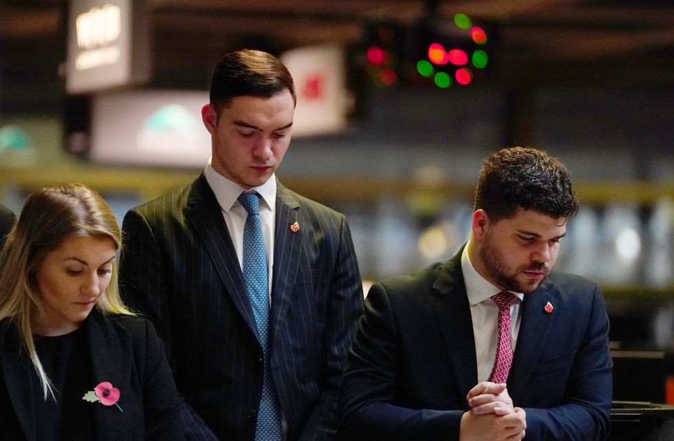 Members of the public fall silent at Lloyd's in London.