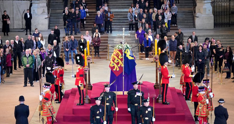 Members of the public file past the coffin of Queen Elizabeth II, draped in the Royal Standard with the Imperial State Crown and the Sovereign's orb and sceptre, lying in state on the catafalque in Westminster Hall, at the Palace of Westminster, London, ahead of her funeral on Monday. Picture date: Thursday September 15, 2022. Yui Mok/Pool via REUTERS