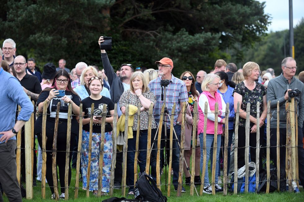 Members of the public in Dundee ahead of the passing of Queen Elizabeth II's coffin on its journey from Balmoral to Edinburgh, where it will lie at rest at the Palace of Holyroodhouse. Picture date: Sunday September 11, 2022.