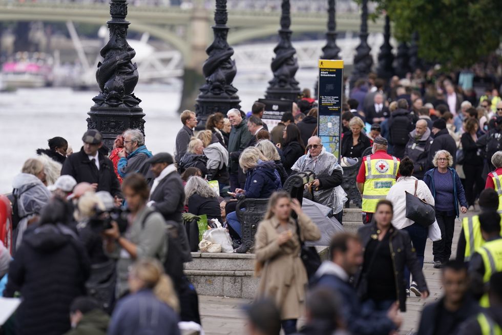 Members of the public join the queue on the South Bank, as they wait to view Queen Elizabeth II lying in state ahead of her funeral on Monday. Picture date: Wednesday September 14, 2022.