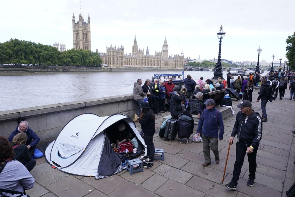 Members of the public join the queue on the South Bank, as they wait to view Queen Elizabeth II lying in state ahead of her funeral on Monday. Picture date: Wednesday September 14, 2022.