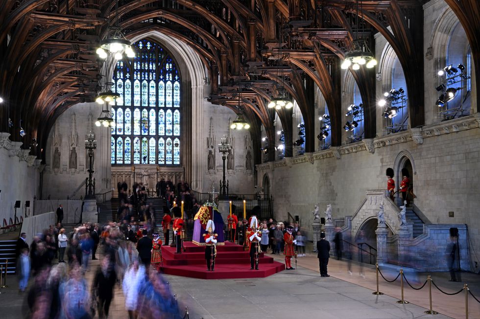 Members of the public view the coffin of Queen Elizabeth II, lying in state on the catafalque in Westminster Hall, at the Palace of Westminster, London, ahead of her funeral on Monday. Picture date: Sunday September 18, 2022.