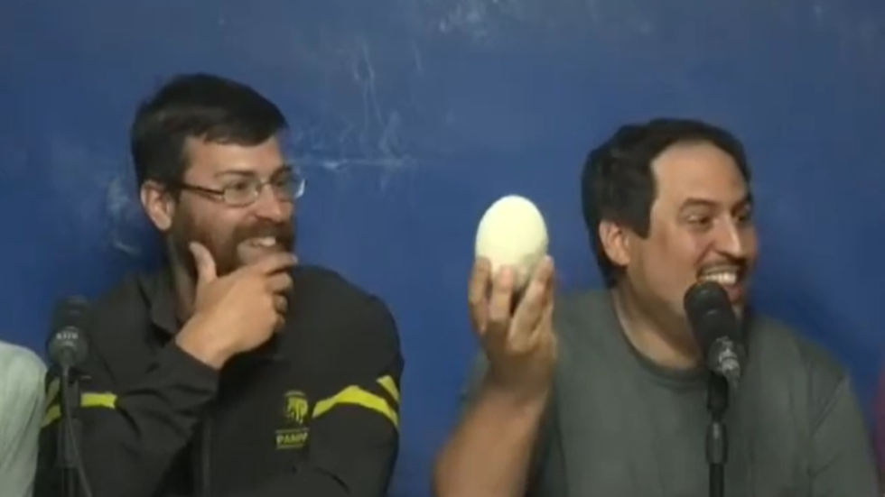 Members of the research team with the egg