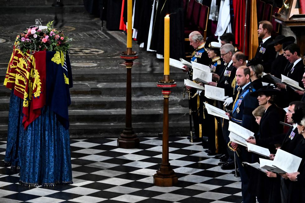 Members of the Royal family and guests sing as the coffin of Queen Elizabeth II, draped in the Royal Standard, lies by the altar during the State Funeral Service for Britain's Queen Elizabeth II, at Westminster Abbey in London on September 19, 2022.     BEN STANSALL/Pool via REUTERS
