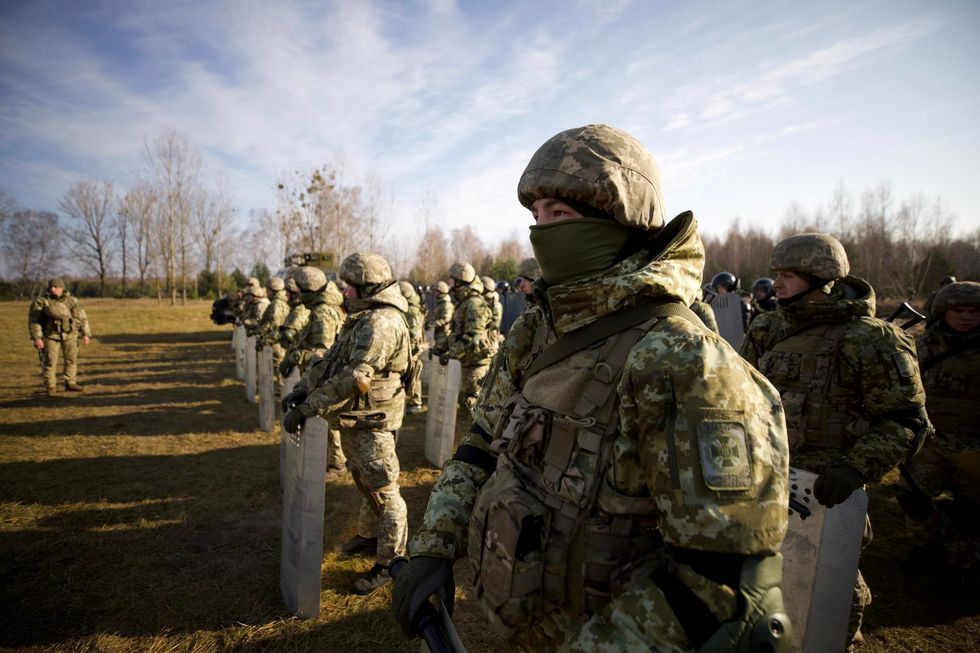 Members of the Ukrainian State Border Guard Service line up at the border with Belarus in Volyn region.